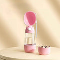 Pink 2-in-1 portable dog and cat water bottle with removable food container.