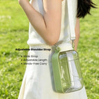 Portable dog and cat water and food bottle with adjustable shoulder strap for hands-free carrying.