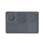 Gray rectangular silicone lick mat feeding tray for dogs and cats with an integrated food bowl and multiple textured licking surfaces.