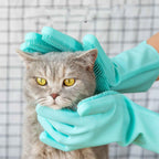 Silicone grooming gloves gently brushing and massaging a cat with soft silicone bristles.