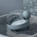 Gray silicone cat and dog bath brush with built-in shampoo dispenser.