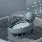 Gray silicone cat and dog bath brush with built-in shampoo dispenser.