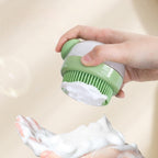 Green silicone bath brush dispensing rich foam for bathing cats and dogs.