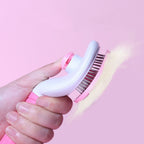 Self-cleaning pet slicker brush with one-button hair release.